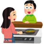 対面キッチンで料理をする女性と会話する男性のイラスト